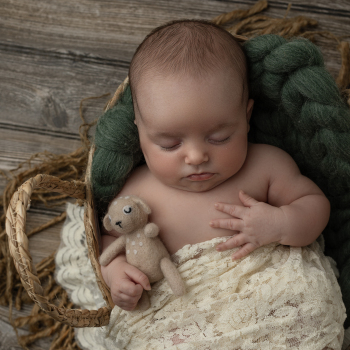 a baby laying in a basket