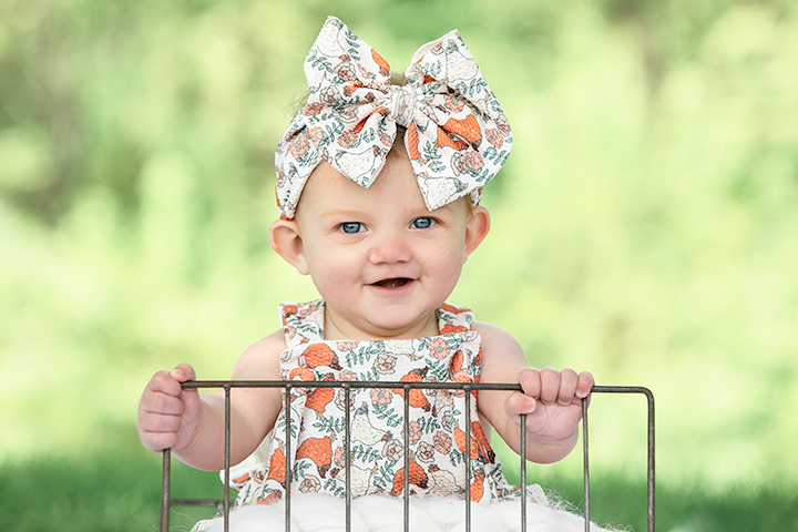 little girl, sitting outside